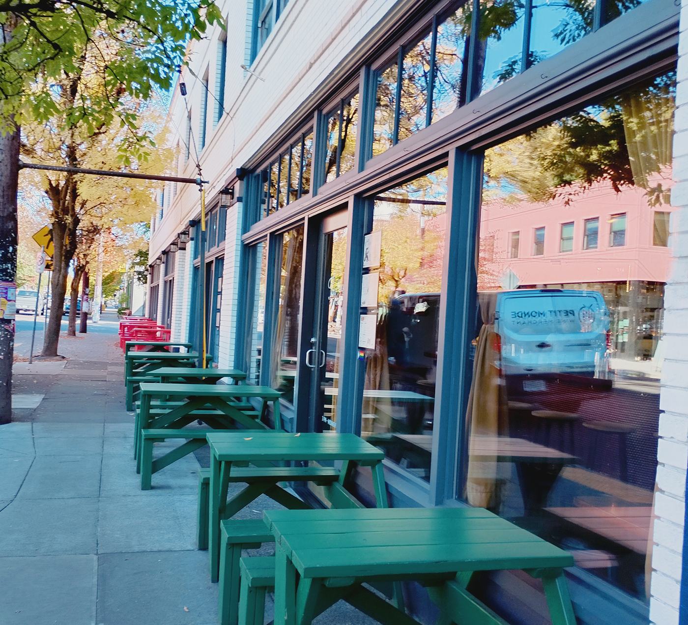 Outdoor café tables along a storefront street in Portland, Oregon